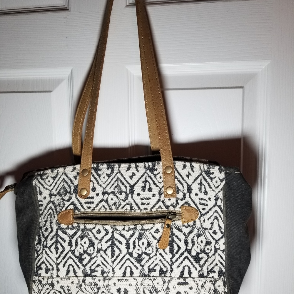 Myra bag, genuine cow hide, leather, and canvas material.